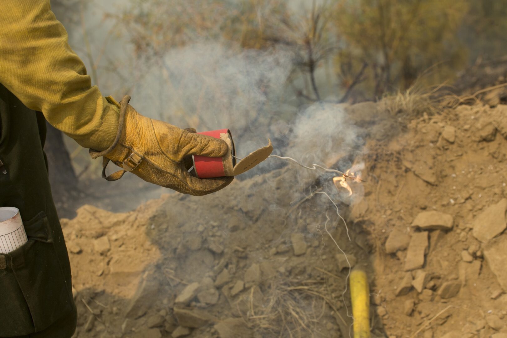 Controlled burn with flare in hand