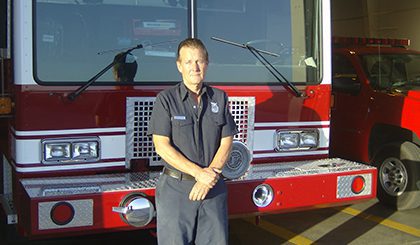 Man posing with fire engine