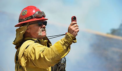 Firefighter using device in smoky area