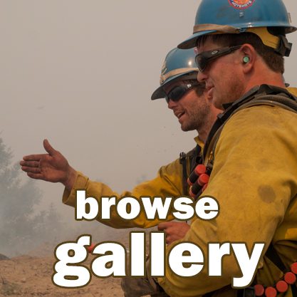 Firefighters discussing strategy in smoky environment